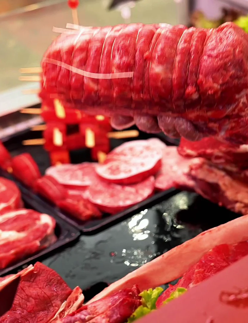 Tied beef roast on display at a butcher shop
