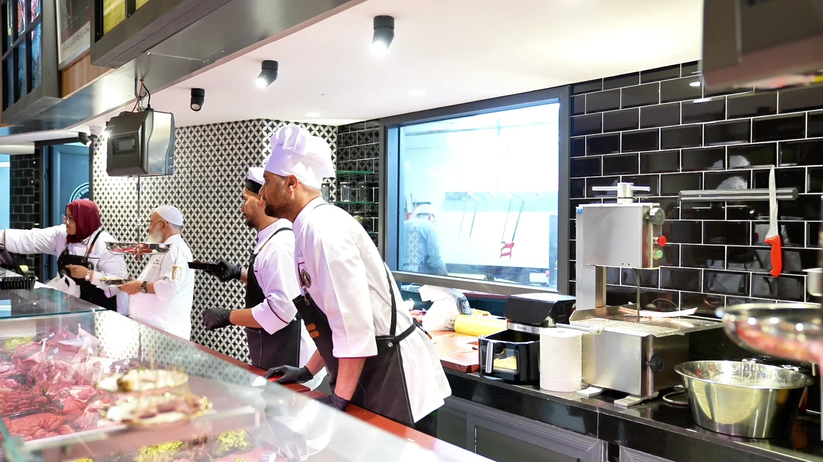 Butchers at work behind the counter